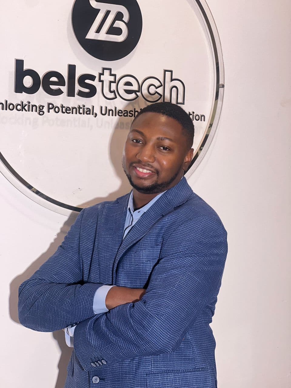 Man standing in front of the Belstech sign