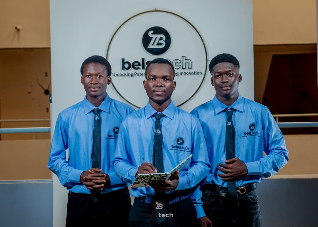 Three Belstech students in blue uniforms standing together