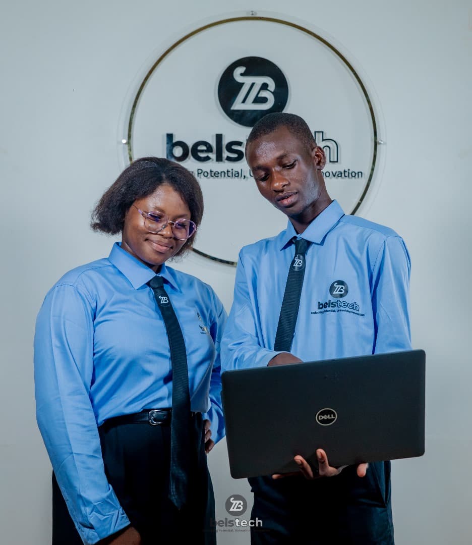 Two Belstech learners working together at a laptop